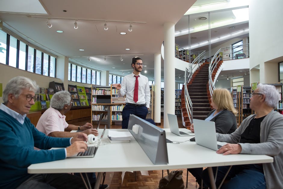 Team engaged in a collaborative meeting in a modern library setting.